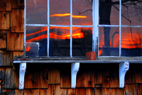Sunset reflected in a shed window